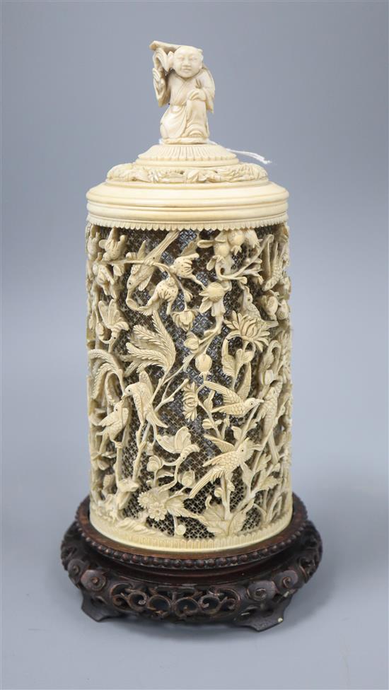 A late 19th century Chinese carved ivory lidded jar on a wood stand